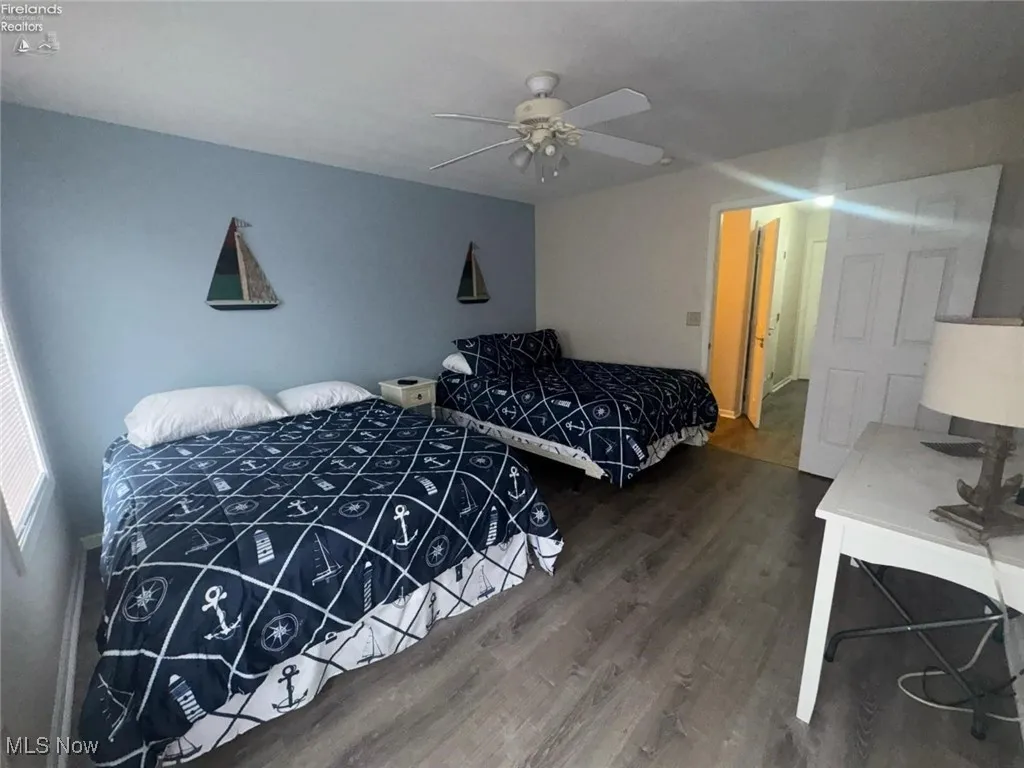 Bedroom featuring wood finished floors and a ceiling fan