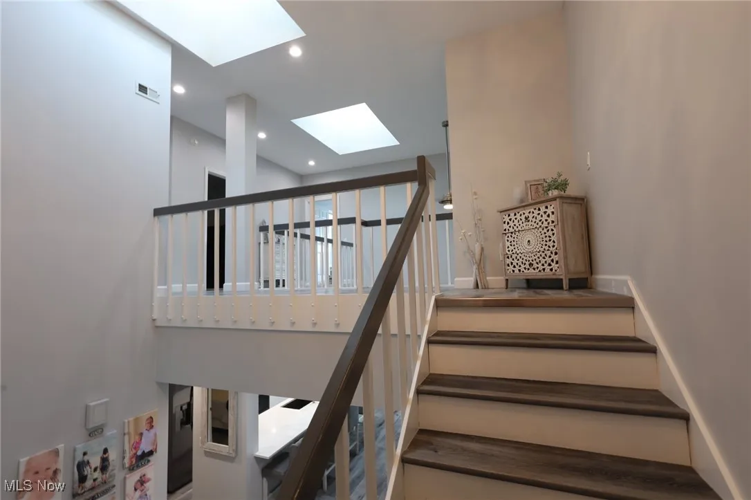 Staircase with a skylight and recessed lighting