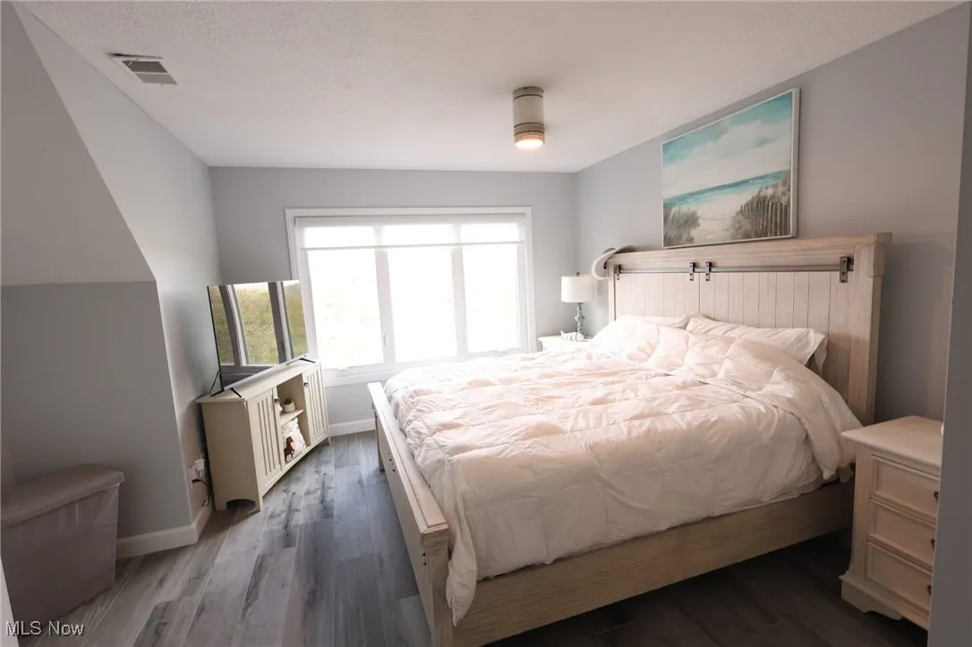 Bedroom featuring baseboards and wood finished floors