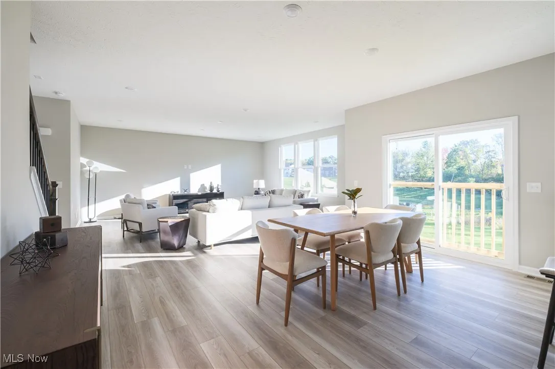 Dining space with light wood-type flooring and stairs