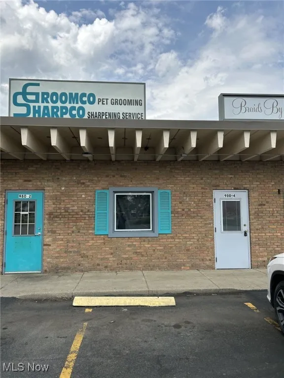 View of building exterior with uncovered parking