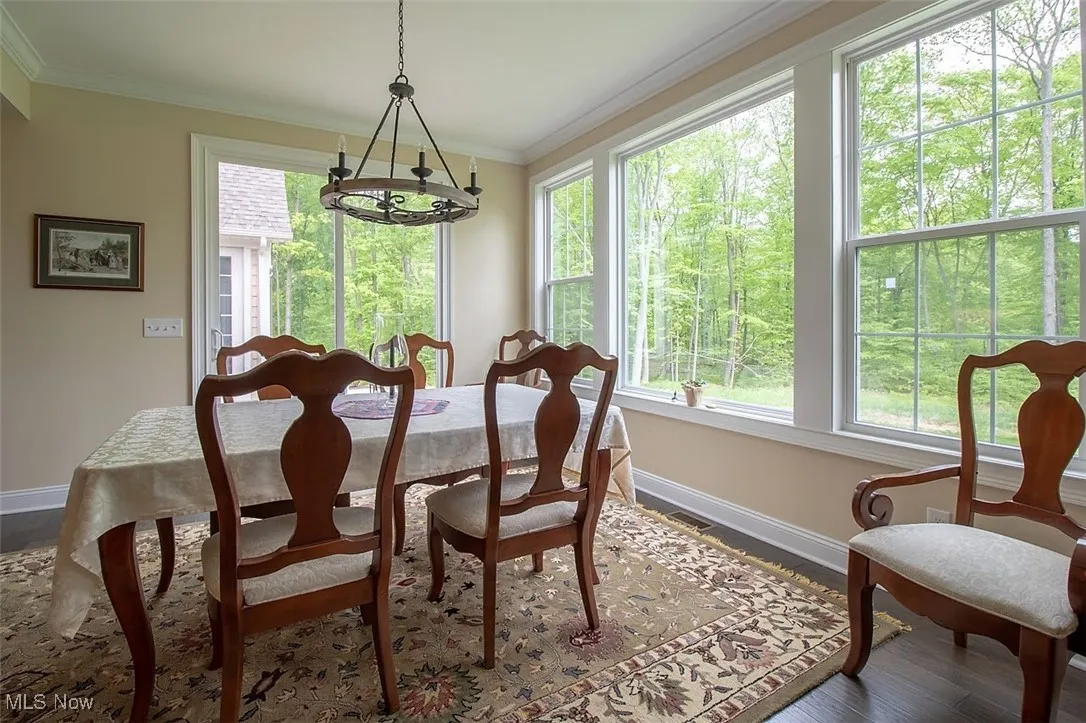 Virtually staged Dining space off kitchen overlooks the spectacular private lot