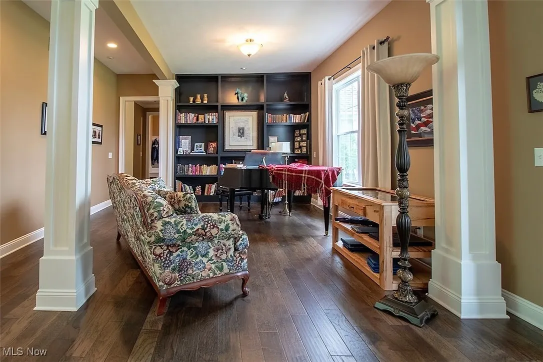 Virtually staged Dining/Music room featuring hardwood floors and ornate columns