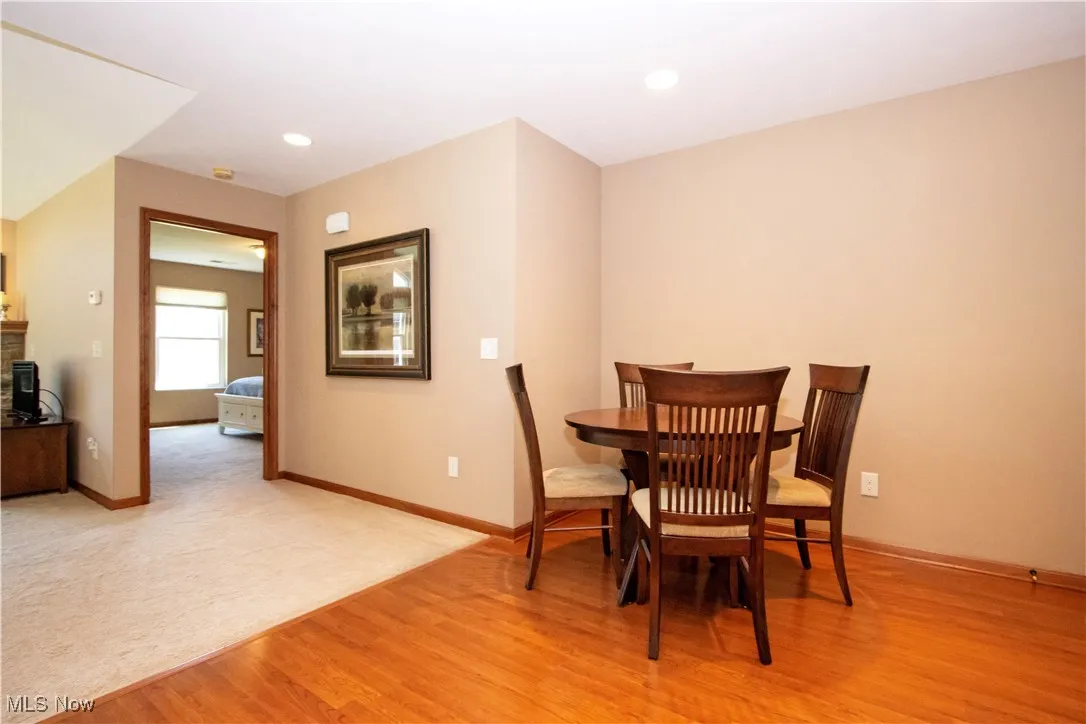 Dining space featuring light wood finished floors, baseboards, and recessed lighting