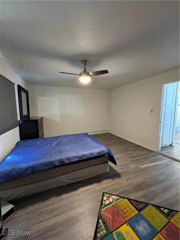 Bedroom featuring wood finished floors and ceiling fan