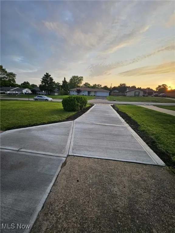 View of home's community with a lawn