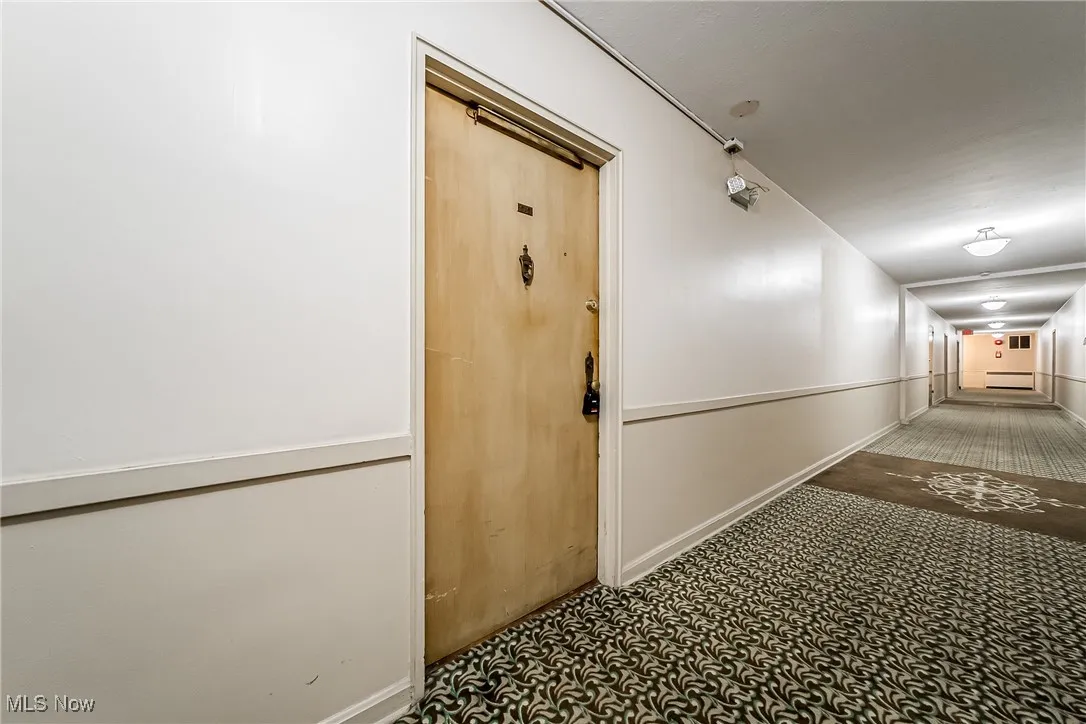 Corridor with carpet floors and baseboards
