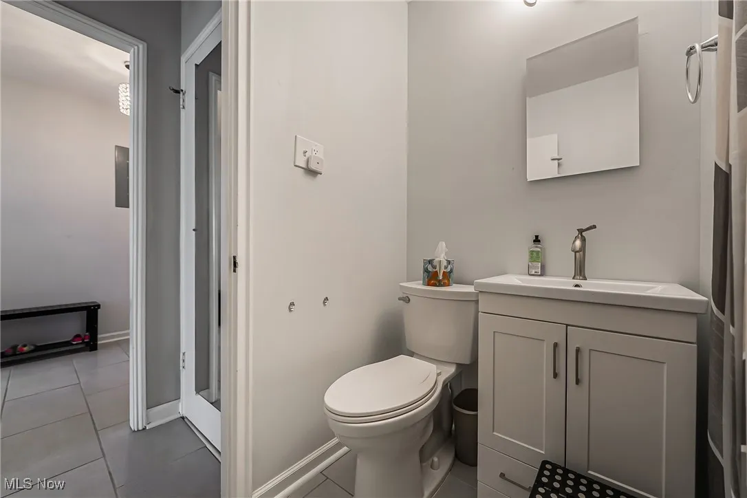 Bathroom featuring tile patterned flooring and vanity