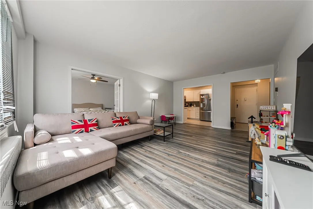Living area featuring wood finished floors and a ceiling fan