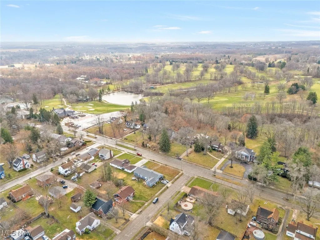 Aerial overview of property's location with a large body of water and nearby suburban area