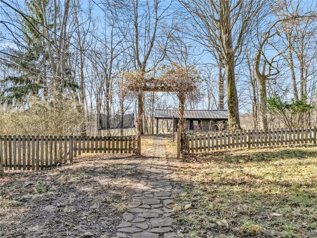 View of yard with fence and an outbuilding