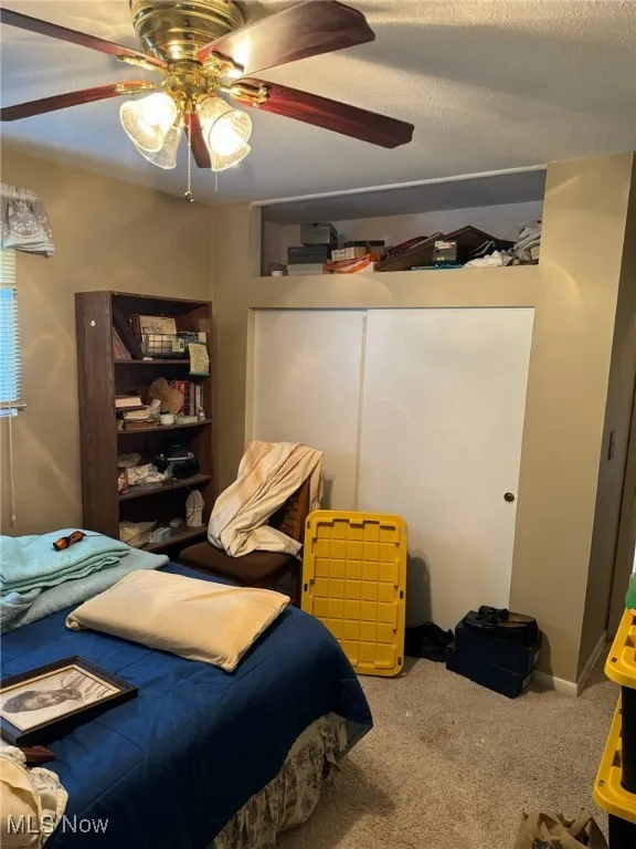 Bedroom featuring carpet and a ceiling fan