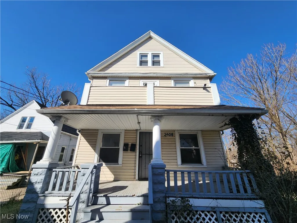 View of front of house featuring covered porch and a balcony