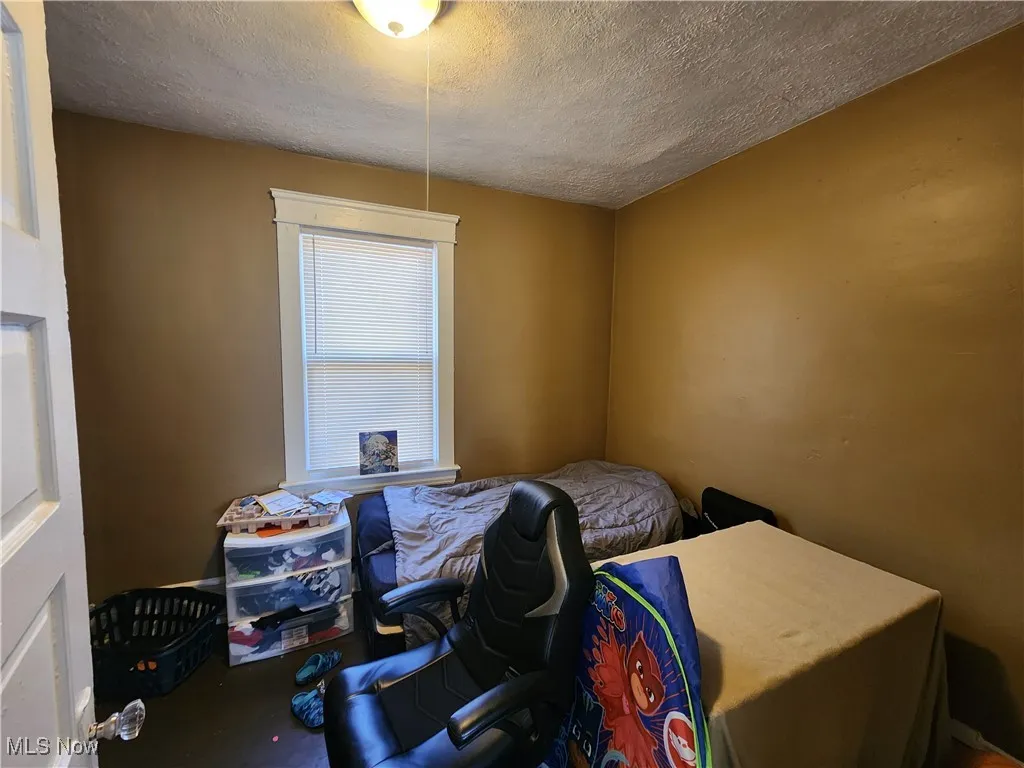 Bedroom featuring a textured ceiling