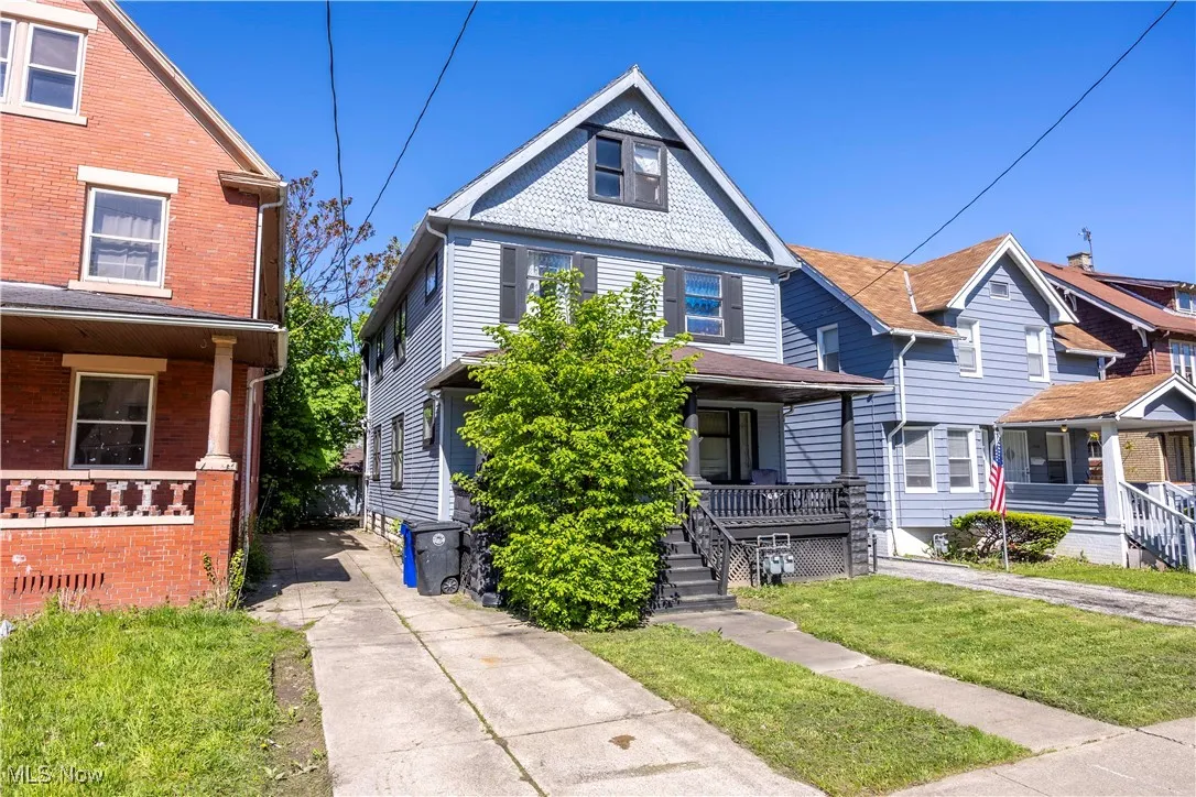 View of front of house featuring a porch, brick siding, and a front yard