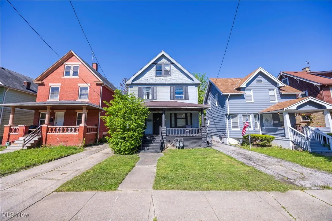 View of front of home featuring covered porch and a front lawn