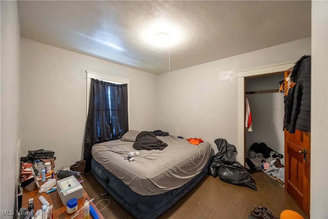 Bedroom with hardwood / wood-style floors