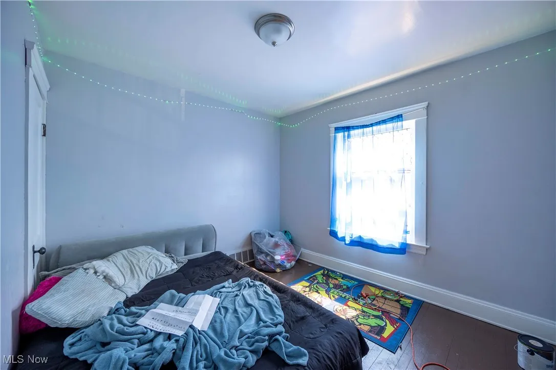 Bedroom with baseboards and wood finished floors