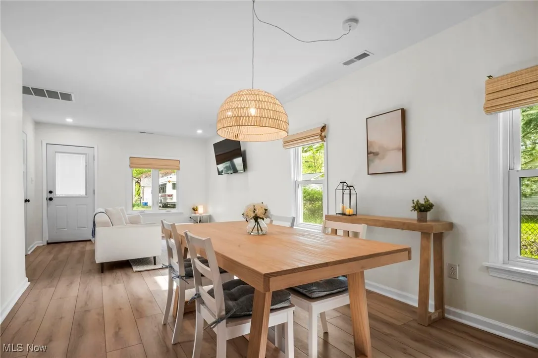 Dining room featuring baseboards, healthy amount of natural light, light wood-type flooring, and recessed lighting
