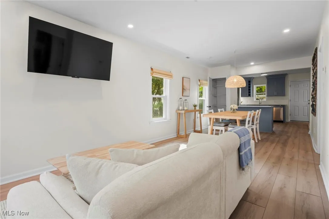 Living area with light wood-style flooring, recessed lighting, and baseboards