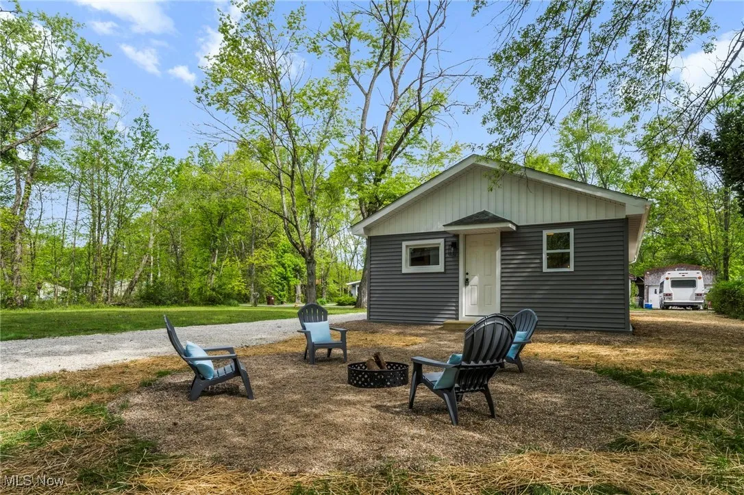 Rear view of house with an outdoor fire pit