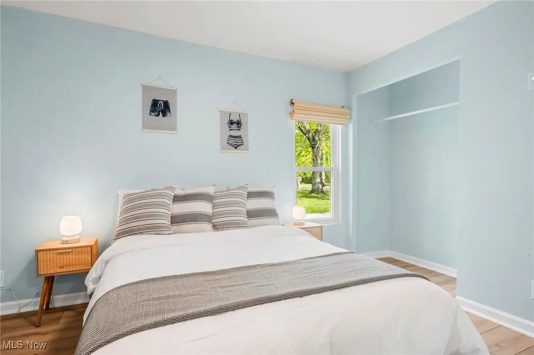 Bedroom with baseboards and light wood finished floors