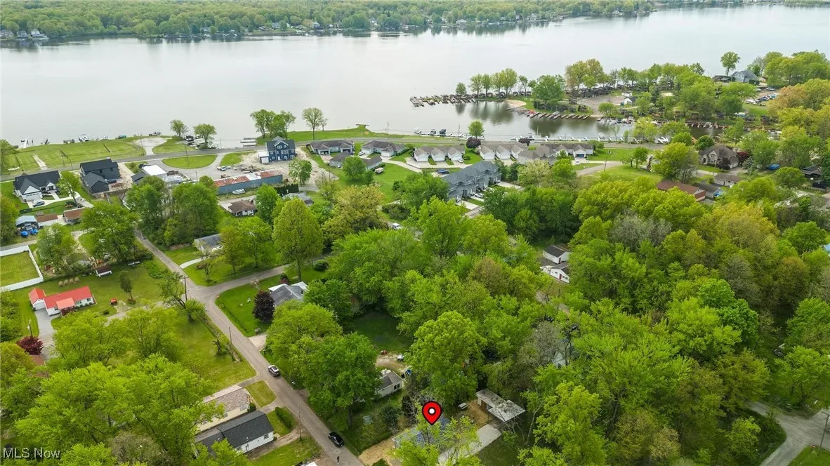 Aerial perspective of suburban area featuring a nearby body of water