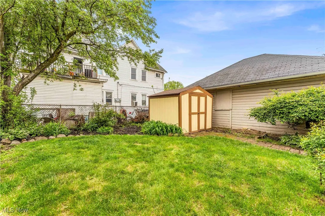 View of yard featuring a storage shed and an outdoor structure