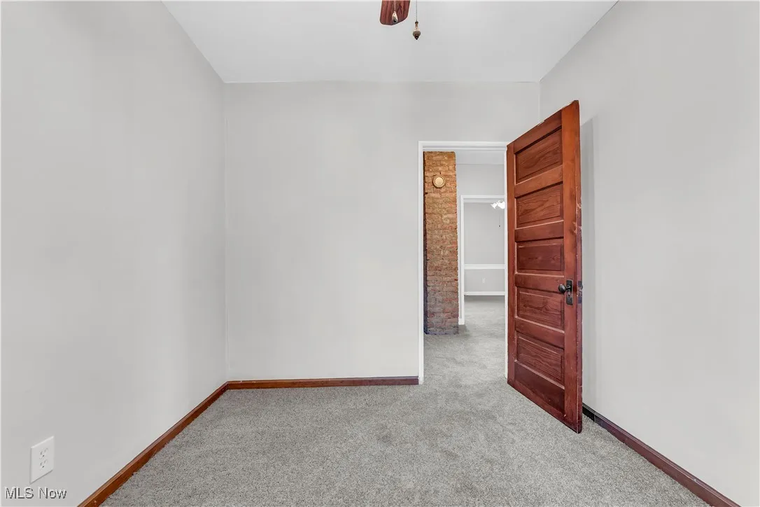 Unfurnished room featuring carpet floors and baseboards