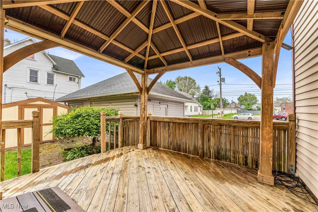 Wooden terrace with a storage shed, an outbuilding, and a gazebo