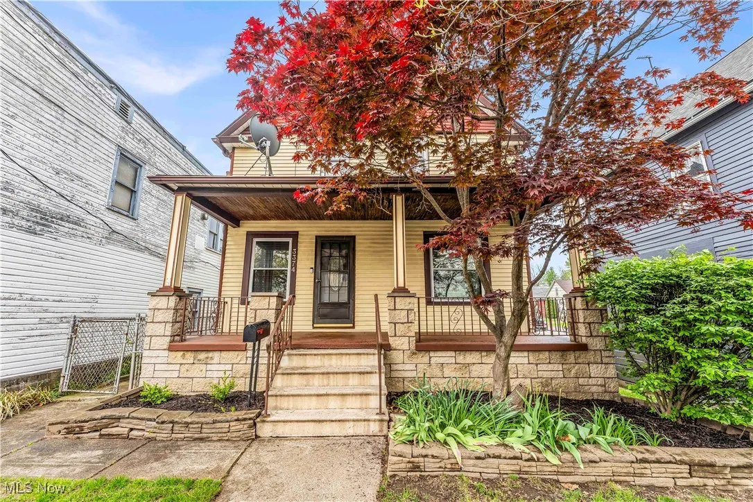 View of front of property featuring a porch and a gate