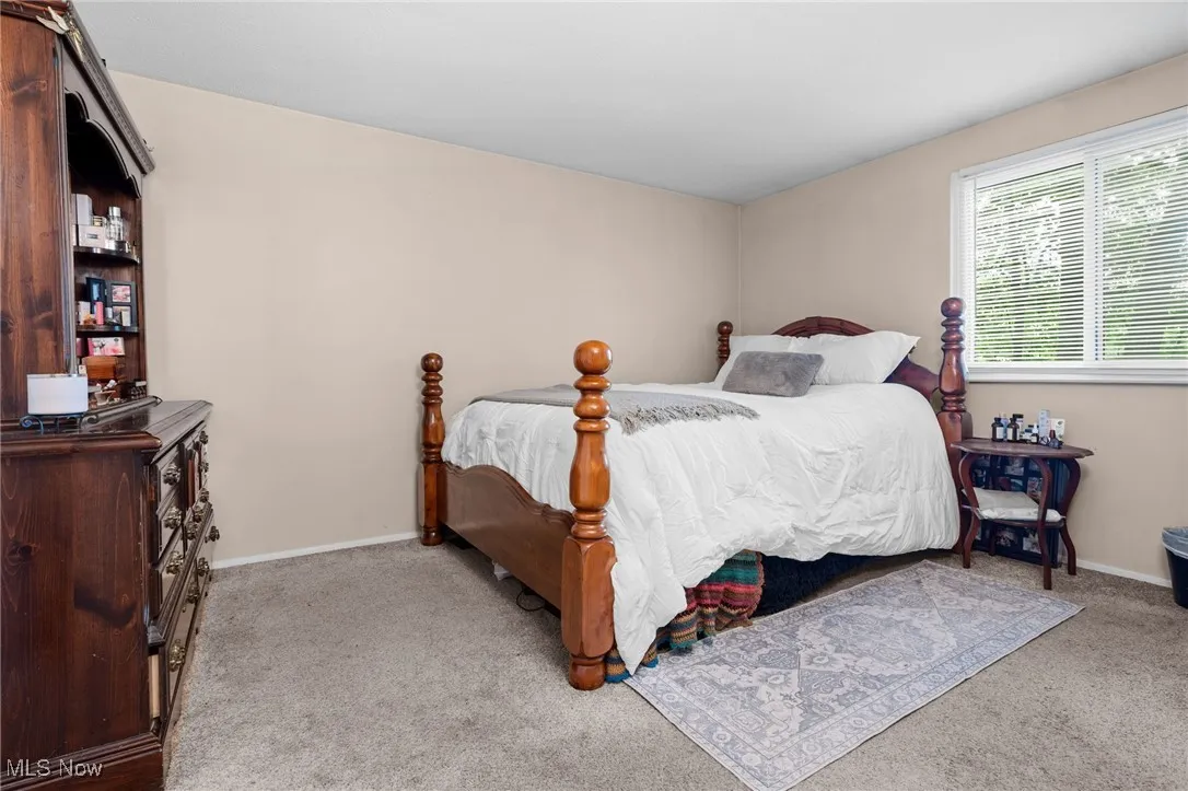 Carpeted bedroom with baseboards