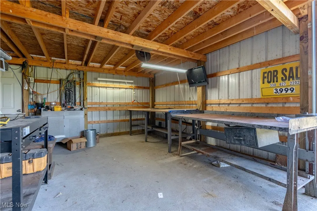 Garage with a workshop area and metal wall