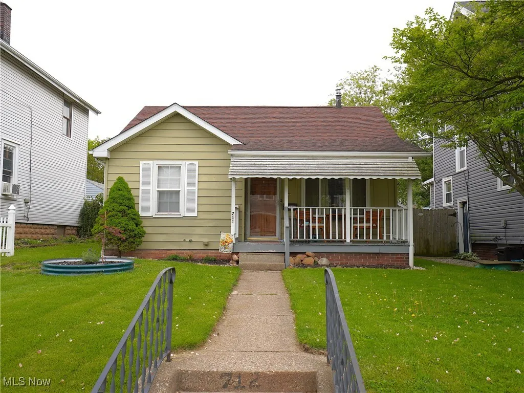 Bungalow-style home featuring a porch and roof with shingles