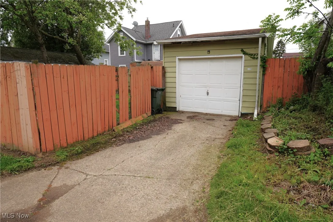 Garage with driveway and fence