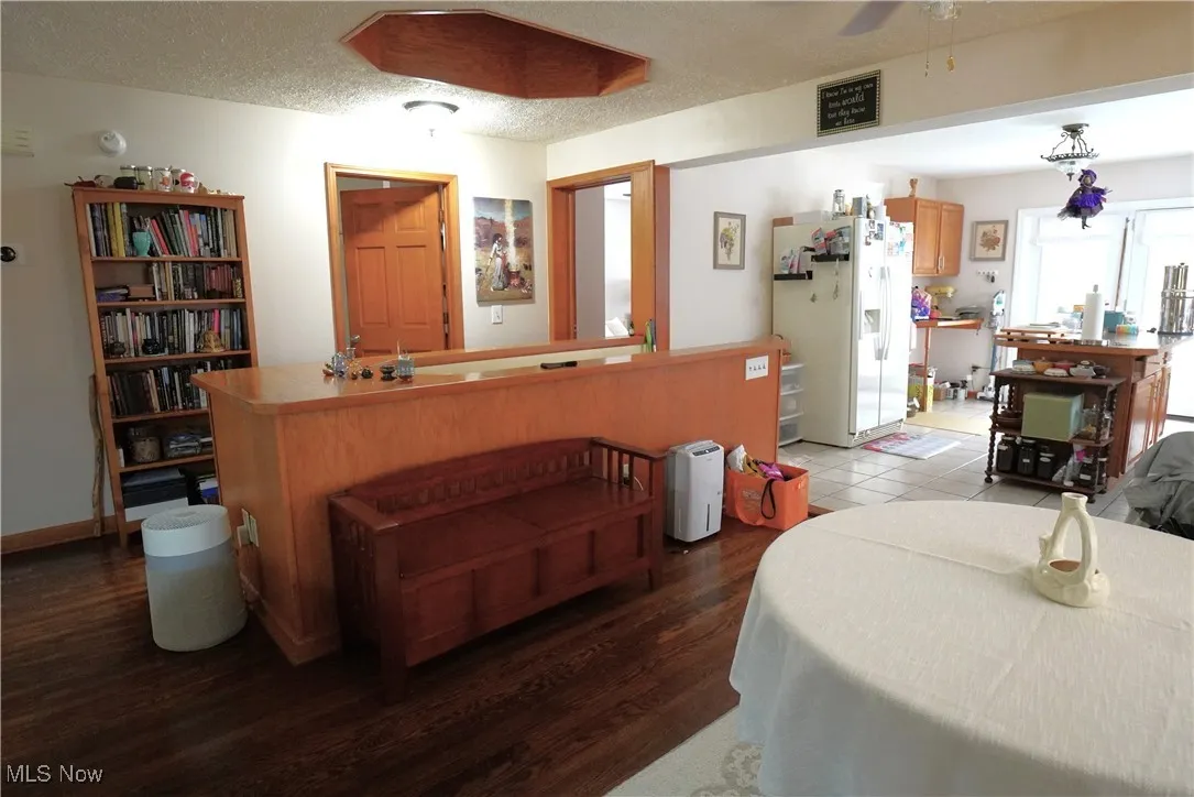 Dining space with ceiling fan and light wood-style flooring