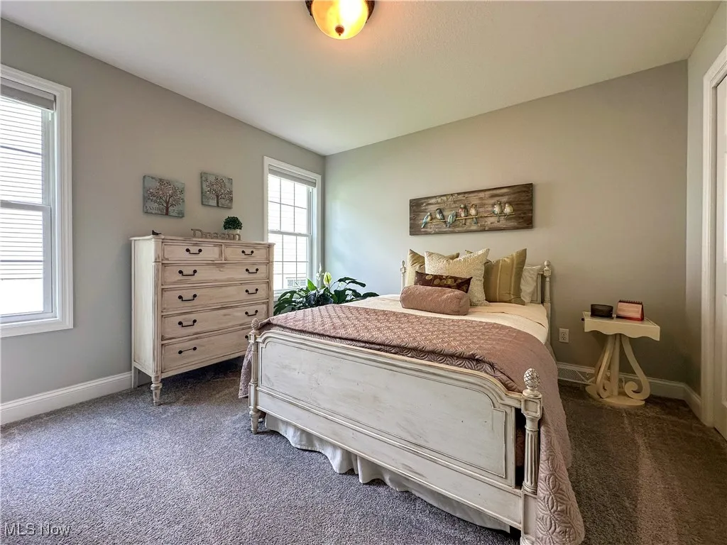 Bedroom with carpet flooring and baseboards