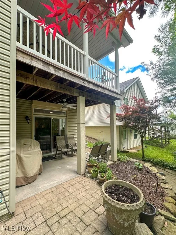 View of patio / terrace with a balcony and a ceiling fan