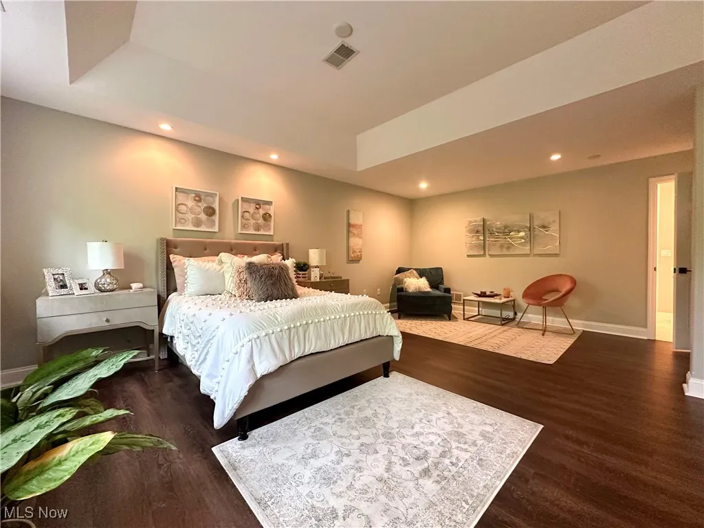 Bedroom with wood finished floors, recessed lighting, and baseboards