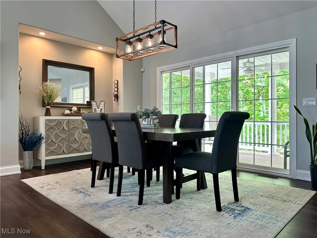 Dining room with vaulted ceiling, baseboards, wood finished floors, and recessed lighting