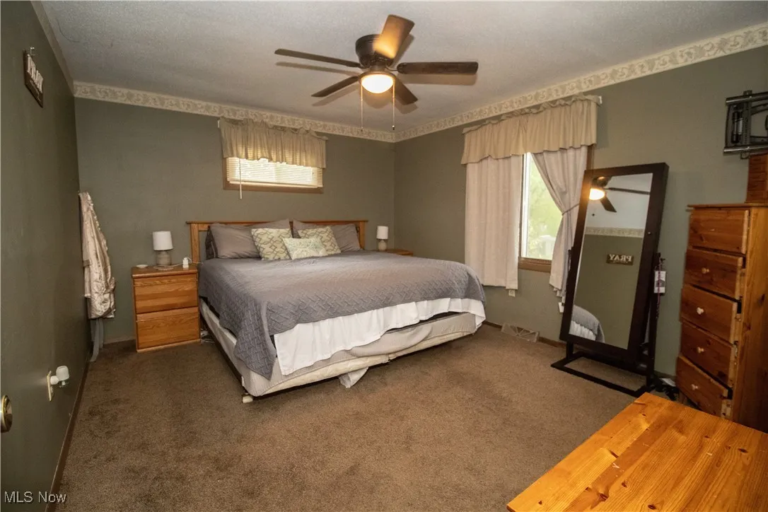 Bedroom featuring carpet flooring and ceiling fan