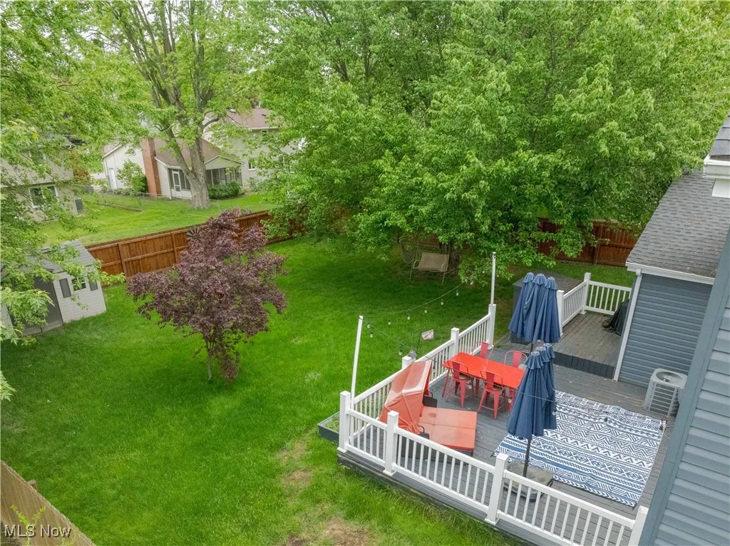 View of yard featuring outdoor dining space and a wooden deck