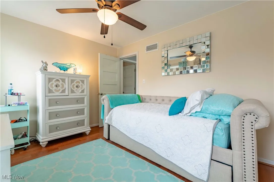 Bedroom with wood finished floors and ceiling fan