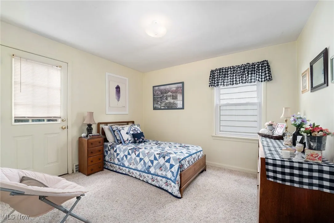 Carpeted bedroom featuring baseboards