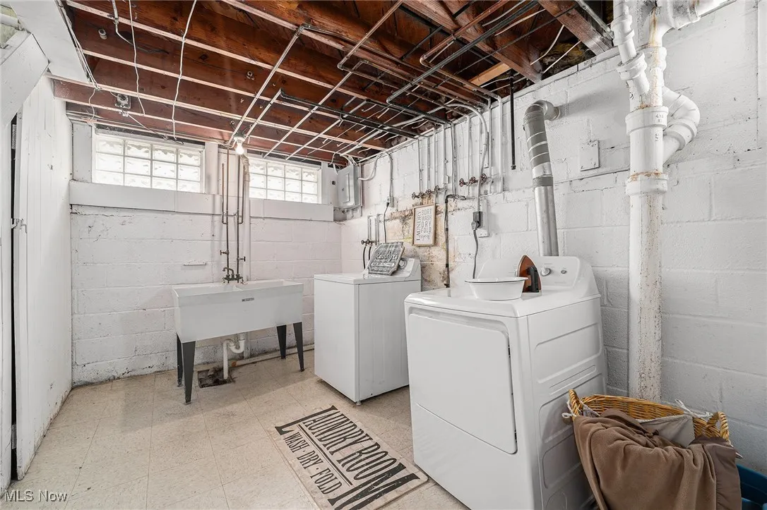 Laundry room featuring washer and dryer and light floors