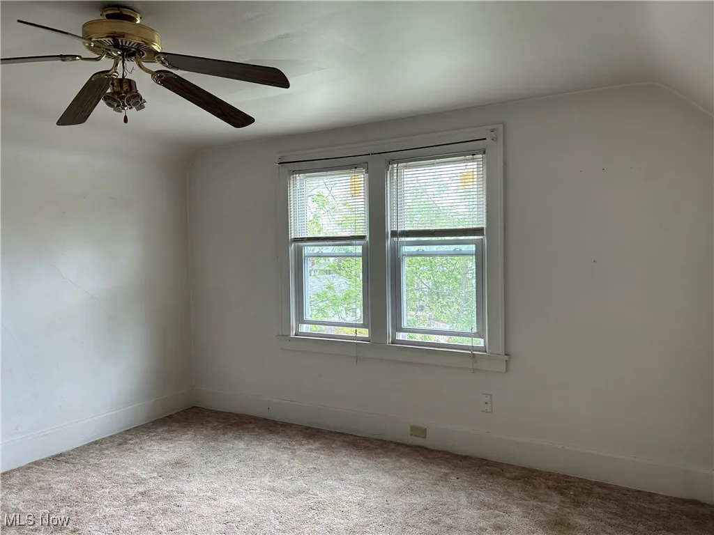 Second Floor Apartment bedroom with light colored carpet, a ceiling fan, and baseboards and extra large closet.