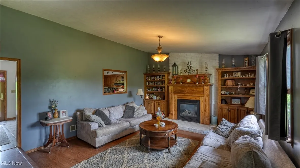 Living area with a fireplace and wood finished floors