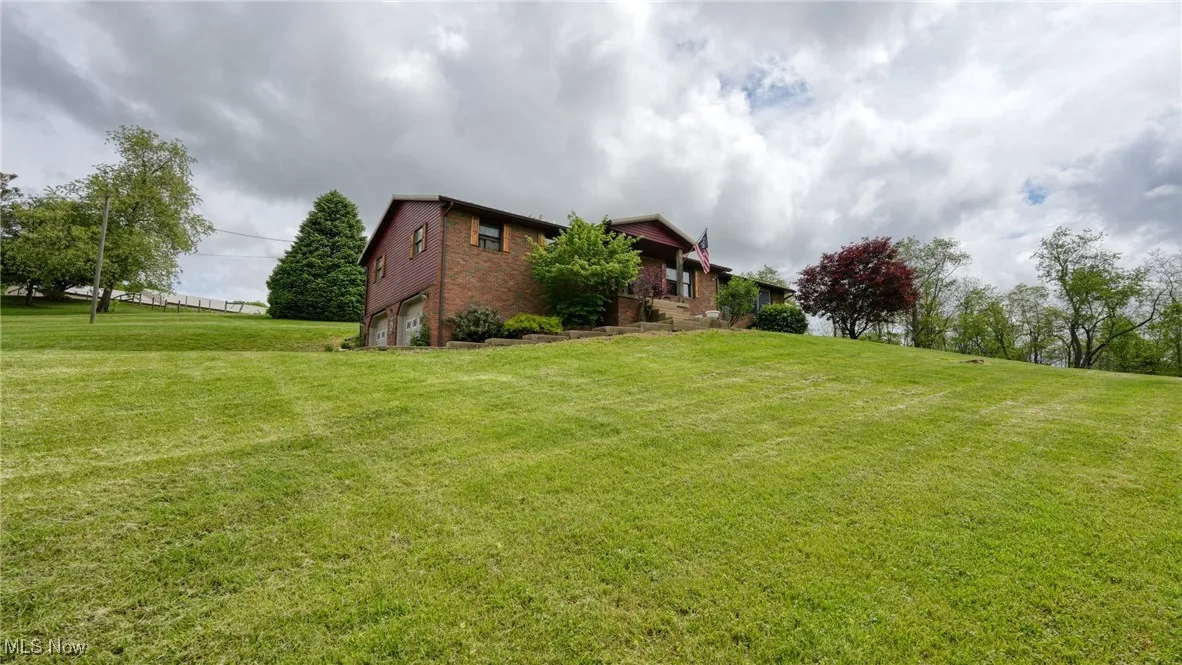 View of green lawn with a garage