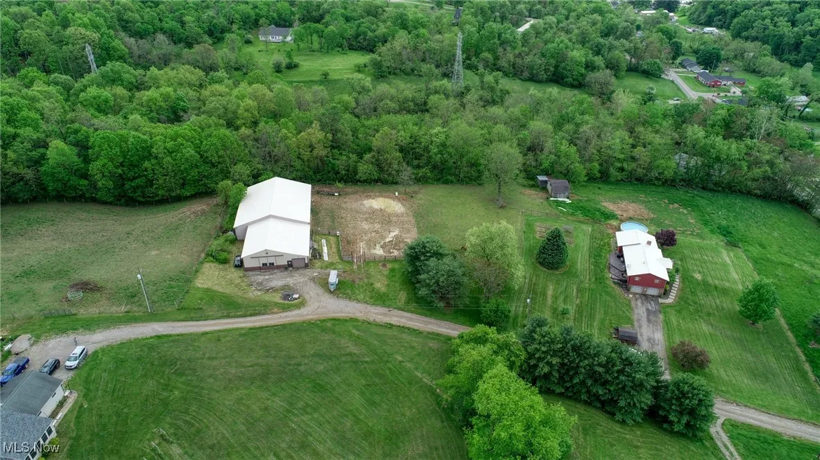 Aerial overview of property's location with a heavily wooded area