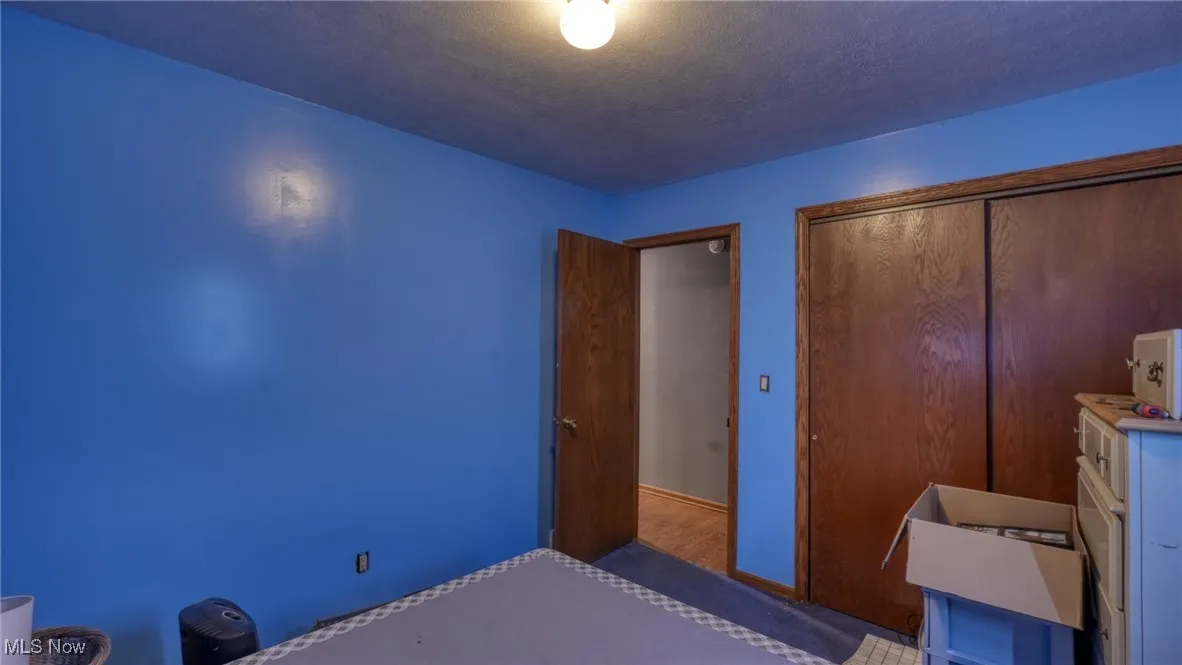 Unfurnished bedroom with a textured ceiling and a closet